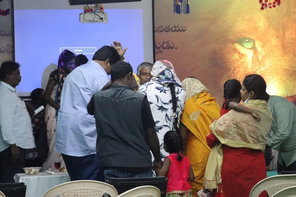 Congregation praying together at Agape Family Centre